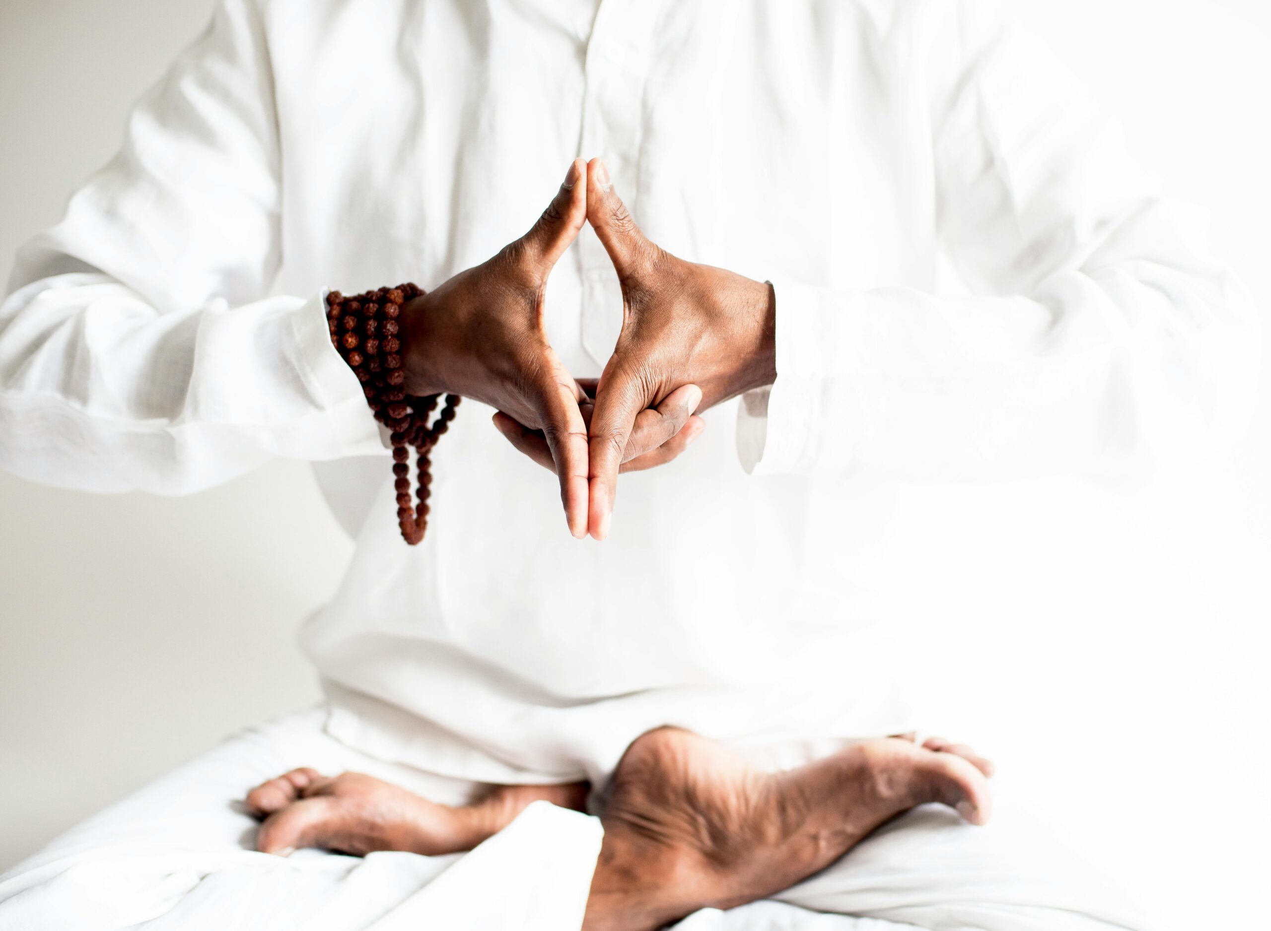 A peaceful yoga practice focused on meditation and balance, captured in serene white tones.